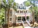 Elegant two-story home boasts a double porch adorned with an American flag, offering a charming curb appeal at 2225 Black Oak Ct, Mount Pleasant, SC 29466