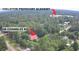 Aerial shot of the home with a red roof and the Colleton Preparatory Academy in the distance at 236 Chamblee Rd, Walterboro, SC 29488