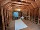 Unfinished attic space with exposed beams, insulation, and natural light at 236 Chamblee Rd, Walterboro, SC 29488