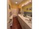 Bright bathroom featuring double sinks, a tub and shower combination, and decorative lighting at 236 Chamblee Rd, Walterboro, SC 29488