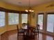 Cozy dining room with a round table, chandelier, and large windows overlooking the backyard at 236 Chamblee Rd, Walterboro, SC 29488