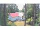 Rear exterior view of a home with a red roof, white siding, and a small back deck at 236 Chamblee Rd, Walterboro, SC 29488