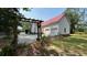 Side view of the home showing the two-car garage, siding and the red roof at 236 Chamblee Rd, Walterboro, SC 29488