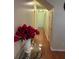 Hallway with hardwood floors, neutral walls, and a decorative table with a floral arrangement at 236 Chamblee Rd, Walterboro, SC 29488