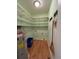 Functional laundry room with ample shelving, wooden floors, and a utility sink at 236 Chamblee Rd, Walterboro, SC 29488