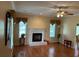 Bright living room with a fireplace, hardwood floors, and natural light from two windows at 236 Chamblee Rd, Walterboro, SC 29488