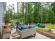 Outdoor patio with wicker seating, grilling area and views of lush green backyard at 259 Camber Rd, Huger, SC 29450