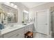Bright bathroom featuring double sinks, modern fixtures, a large mirror, and decorative details at 259 Camber Rd, Huger, SC 29450