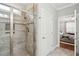 Bathroom showcases a tiled shower with glass door, white door to the bedroom, and stylish fixtures at 259 Camber Rd, Huger, SC 29450
