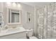 Clean bathroom with white vanity, patterned shower curtain, and decorative accents enhancing the space at 259 Camber Rd, Huger, SC 29450