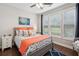Bright bedroom features a ceiling fan, bedside table, and comfy bed with decorative seashell pillows and blanket at 259 Camber Rd, Huger, SC 29450