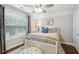 Bright bedroom with a white wicker bed, beach-themed artwork, and a ceiling fan for comfort at 259 Camber Rd, Huger, SC 29450