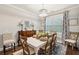 Elegant dining room featuring a white dining table set for four, a dark wood hutch, and modern decor at 259 Camber Rd, Huger, SC 29450