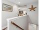 Upstairs hallway displaying nautical themed decorations and artwork, leading into a cozy, well-lit living area at 259 Camber Rd, Huger, SC 29450