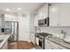 Well-appointed kitchen with stainless steel appliances, granite countertops, and stylish white cabinetry at 259 Camber Rd, Huger, SC 29450