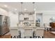 Spacious kitchen with a large island, barstool seating, stainless steel appliances, and modern pendant lighting at 259 Camber Rd, Huger, SC 29450