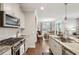 Open kitchen boasts an island with a sink, stainless steel appliances, and hardwood floors at 259 Camber Rd, Huger, SC 29450