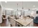 Bright kitchen with an island, dining and living areas, stainless steel appliances, and pendant lighting at 259 Camber Rd, Huger, SC 29450