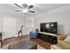 Inviting living room featuring hardwood floors, ceiling fan, television, and comfy seating arrangements at 259 Camber Rd, Huger, SC 29450