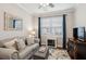 Cozy living room features a comfortable gray couch, decorative pillows, and a charming fireplace at 259 Camber Rd, Huger, SC 29450