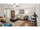Cozy living room with neutral sofa, patterned pillows, bookshelves, and an ottoman on hardwood floors at 259 Camber Rd, Huger, SC 29450
