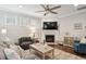 Stylish living room boasts a fireplace with mounted TV, comfortable seating, and elegant decor at 259 Camber Rd, Huger, SC 29450