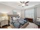 Serene main bedroom with a paisley patterned bed, blue accents, and stylish decor, creating a relaxing retreat at 259 Camber Rd, Huger, SC 29450