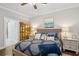 Main bedroom showcasing a bed with a paisley coverlet, bedside tables, and a decorative cabinet at 259 Camber Rd, Huger, SC 29450