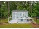 Storage shed with a deck, surrounded by a fenced backyard at 259 Camber Rd, Huger, SC 29450