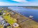 Stunning aerial view of waterfront homes with private docks along a scenic coastline under a clear blue sky at 2769 Rivertowne Pkwy, Mount Pleasant, SC 29466