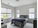 Bright bedroom with two windows, grey comforter on the bed, neutral decor at 2769 Rivertowne Pkwy, Mount Pleasant, SC 29466