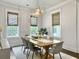 Bright dining room with large windows, modern light fixture, and decorative zebra stripe ceiling at 2769 Rivertowne Pkwy, Mount Pleasant, SC 29466