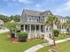 Charming two-story home with a spacious porch and lush landscaping at 2769 Rivertowne Pkwy, Mount Pleasant, SC 29466