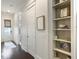 Hallway with dark hardwood floors leading to an outdoor balcony and convenient built-in shelving at 2769 Rivertowne Pkwy, Mount Pleasant, SC 29466