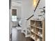 Hallway with dark hardwood flooring and built-in shelving next to stairway leading to a bedroom at 2769 Rivertowne Pkwy, Mount Pleasant, SC 29466