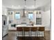 Bright kitchen features white cabinets, stainless steel appliances, marble countertops, and a spacious island at 2769 Rivertowne Pkwy, Mount Pleasant, SC 29466