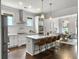 Open kitchen and dining area with white cabinets, marble island, and stainless steel appliances at 2769 Rivertowne Pkwy, Mount Pleasant, SC 29466