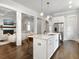 Open kitchen featuring marble island, sink, white cabinets, and stainless steel refrigerator at 2769 Rivertowne Pkwy, Mount Pleasant, SC 29466