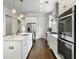 Spacious kitchen featuring stainless steel appliances, white cabinetry, and hardwood floors at 2769 Rivertowne Pkwy, Mount Pleasant, SC 29466