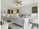 Bright main bedroom with ceiling fan, french doors, and hardwood floors at 2769 Rivertowne Pkwy, Mount Pleasant, SC 29466