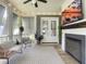 Inviting screened-in porch featuring a cozy seating area and a fireplace with a mounted television at 2769 Rivertowne Pkwy, Mount Pleasant, SC 29466