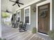 Charming covered porch featuring rocking chairs, a lovely wreath, and a welcoming entrance at 2769 Rivertowne Pkwy, Mount Pleasant, SC 29466