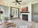 Comfortable screened porch showcasing a seating area and fireplace with a mounted TV at 2769 Rivertowne Pkwy, Mount Pleasant, SC 29466