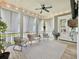 Cozy screened porch featuring ample seating, overhead lighting, and peaceful views of the outdoors at 2769 Rivertowne Pkwy, Mount Pleasant, SC 29466