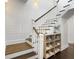 Stairway with dark hardwood treads complimented by white risers and shiplap wall at 2769 Rivertowne Pkwy, Mount Pleasant, SC 29466
