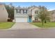 Charming two-story home with a well-manicured lawn, attached garage and a welcoming teal front door at 281 Decatur Dr, Summerville, SC 29486