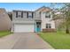 Two-story home featuring a two-car garage, a bright blue front door, and well-maintained landscaping at 281 Decatur Dr, Summerville, SC 29486
