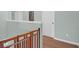 Hallway with a baby gate, leading to additional rooms; includes a decorative sign and hardwood flooring at 281 Decatur Dr, Summerville, SC 29486