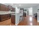 Bright open kitchen with dark wood cabinets, granite counters, stainless appliances, and bar seating at 281 Decatur Dr, Summerville, SC 29486