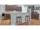 Modern kitchen with dark cabinets, stainless steel appliances, granite countertops, and a breakfast bar at 281 Decatur Dr, Summerville, SC 29486